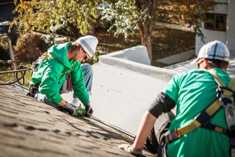 Solar panel installation team working on residential roof